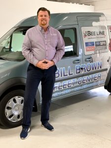 Bill Brown Ford's Jim Stevens standing in front of a Ford Transit Van